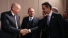 A Turkish Presidential Press photos shows Turkey's President Recep Tayyip Erdogan, left, and Greek Prime Minister Kyriakos Mitsotakis shaking hands during a meeting at the NATO summit in London, Dec. 4, 2019.