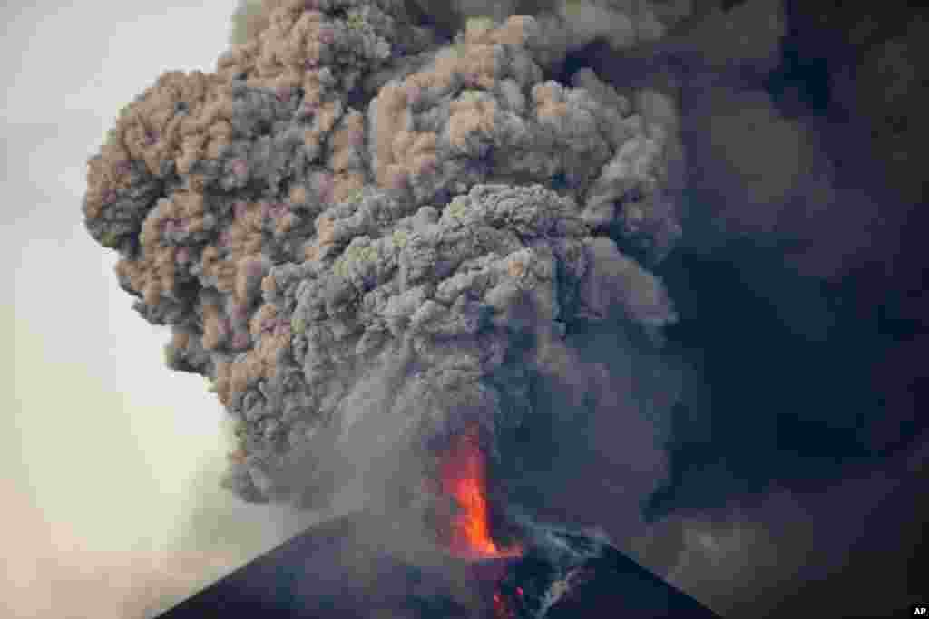 The Momotombo volcano spews a large plume of gas and ash as seen from the rural community of Papalonal, in Leon, Nicaragua.