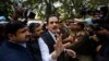 FILE - head of Sahara India conglomerate Subrata Roy speaks to the media as he arrives at the Supreme Court for a hearing in New Delhi, India, Mar. 4, 2014.