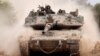 An Israeli army tank drives into position near Israel's southern border with the Gaza Strip on Dec. 11, 2024.