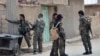 FILE - This photo provided by the Syrian Democratic Forces shows fighters from the SDF patrolling in the northern town of Tabqa, Syria, April 30, 2017. 