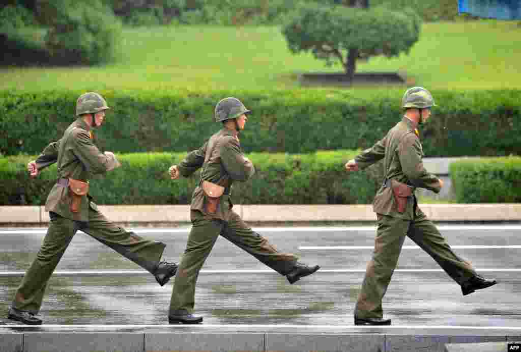 North Korean soldiers march during a repatriation ceremony for the body of a North Korean soldier, who was found dead in the Han river near the border in July, at the truce village of Panmunjom in the Demilitarized Zone dividing the two Koreas.