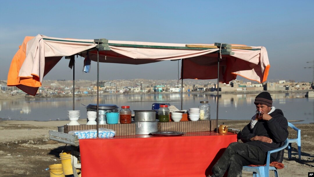 FILE - In this Jan. 28, 2019 file photo, an Afghan street vendor waits for customers on the outskirts of Kabul, Afghanistan. In a Thursday, March 28, 2019 report the Special Inspector General for Afghan Reconstruction, a U.S. watchdog, said that…