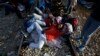 Migrants rest near the border train station of Idomeni, northern Greece, as they wait to be allowed by the Macedonian police to cross the border from Greece to Macedonia, Aug. 20, 2015.