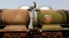 A worker walks atop a tanker wagon to check the freight level at an oil terminal on the outskirts of Kolkata, Nov. 27, 2013. 