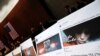 FILE - Examples of Facebook pages are seen as executives appear before the House Intelligence Committee to answer questions related to Russian use of social media to influence U.S. elections, on Capitol Hill in Washington, Nov. 1, 2017. 