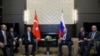 Russian President Vladimir Putin, center right, and Turkish President Recep Tayyip Erdogan , center left, speak during their meeting in the Bocharov Ruchei residence in the Black Sea resort of Sochi, Russia, Oct. 22, 2019.