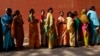 FILE - Women line up to cast their votes outside a polling station during the seventh phase of India's general election at Howrah district in the eastern Indian state of West Bengal, April 30, 2014. 