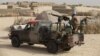 FILE - U.N. peacekeepers from Burkina Faso stand guard during a patrol through a neighborhood on the outskirts of Timbuktu, Mali.