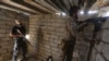 Iraqi Sunni fighters battling Islamic State (IS) group jihadists alongside government forces keep their position on the outskirts of Iraq's Baiji oil refinery, about 200 kilometers north of Baghdad, on May 25, 2015