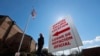 A sign points potential voters to an official polling location during early voting in Dallas, Feb. 26, 2020.