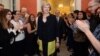 Staff members applaud as Britain's new Prime Minister Theresa May walks into 10 Downing Street after May met Queen Elizabeth in Buckingham Palace, in central London, Britain, July 13, 2016.