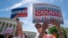 Immigration activists rally outside the Supreme Court as the justices hear arguments over the Trump administration's plan to ask about citizenship on the 2020 census, in Washington, April 23, 2019. 
