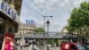Tati's famous blue-and-pink logo soars over the Barbes Rouchechouart metro station in Paris. (Lisa Bryant/VOA)