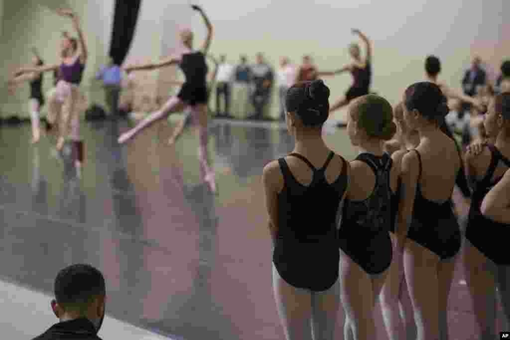 Young ballerinas watch company dancers rehearse "The Nutcracker" at the Cincinnati Ballet rehearsal studios in Cincinnati, Ohio, Dec. 3, 2015. "The Nutcracker," widely popular with ballet companies in North America, has survived over 120 years and is mostly performed during the holiday season.