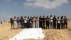 Mourners pray next to the bodies of Palestinians killed in Israeli strikes due to an Israeli military operation in Rafah, amid the ongoing conflict between Israel and Hamas, in Khan Younis, in the southern Gaza Strip, June 19, 2024. 