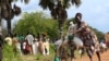 A refugee from South Sudan transports food she received from the World Food Program (WFP) in Palorinya settlement camp for distribution, in Moyo district northern Uganda, Oct. 26, 2017.