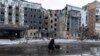 A woman walks past a building damaged by a Russian military strike, amid Russia's attack on Ukraine, in the town of Pokrovsk in Donetsk region, Ukraine, Dec. 12, 2024. 