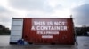 FILE - A shipping container stands in position during a demonstration by the press freedoms organization Reports Sans Frontier (Reporters Without Borders) in Paris, Dec. 16, 2014. Reports from inside Eritrea describe inhumane conditions where prisoners are held in shipping crates in the desert.