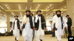 FILE - Afghanistan's Taliban delegation arrive for the agreement signing between Taliban and U.S. officials in Doha, Qatar, Feb. 29, 2020.