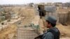 Afghan police officers keep watch at their forward base on the outskirts of Kunduz province, Afghanistan Nov. 26, 2017. 