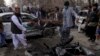 Pakistani volunteers remove a victim at the site of a suicide bombing in Quetta, Feb. 17, 2020.