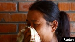 A relative cries as she arrives at a hospital in Kathmandu, where loved ones are undergoing treatment after being rescued from a landslide in northeast Nepal, August 2, 2014.